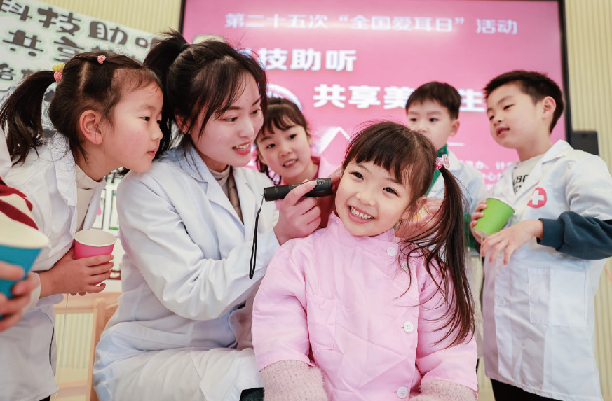 2024年3月1日，浙江省湖州市長(zhǎng)興縣龍山街道中心幼兒園內(nèi)，保健醫(yī)生正在 為孩子們開(kāi)展耳朵健康檢查。